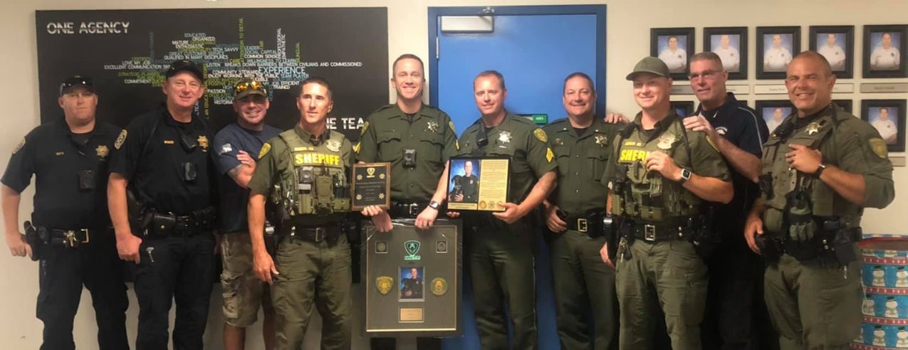 Photo of Teams presenting plaques to Sgt. Van Der Wall